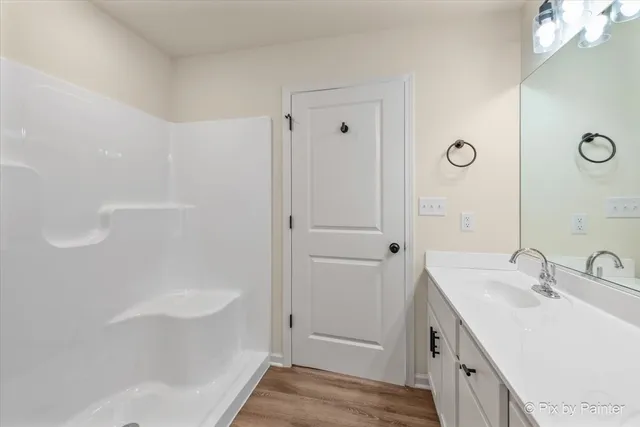 a bathroom with a tub sink and mirror