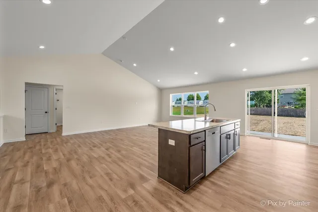 a kitchen with stainless steel appliances granite countertop a stove and a wooden floors