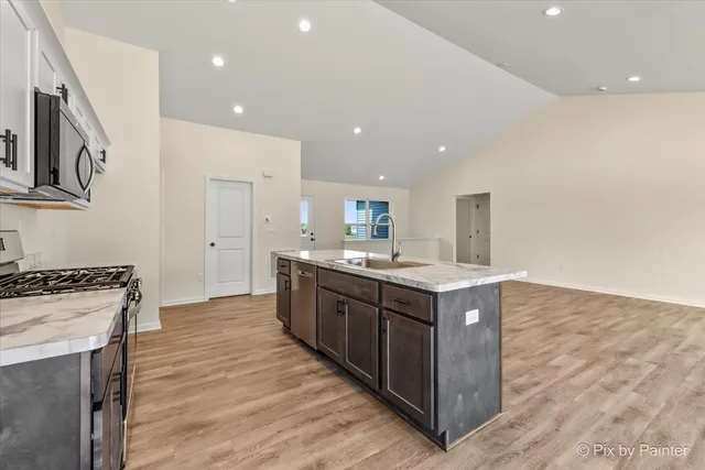 a kitchen with wooden cabinets and a sink