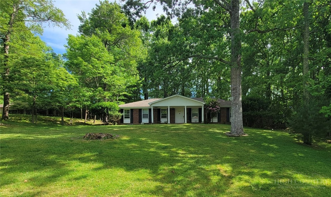 247 Crest Drive Boone, NC 28607 - Photo 18 of 19 a front view of a house with a yard table and chairs