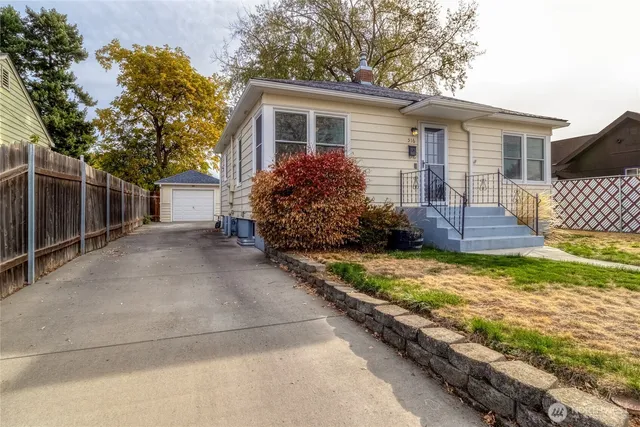 a front view of house with wooden fence