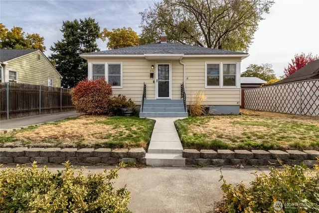 a view of house with yard and sitting area