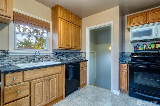 a kitchen with granite countertop a stove and a sink