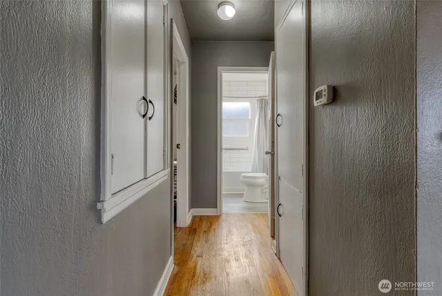 a view of a hallway with wooden floor