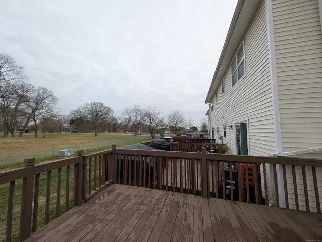 a balcony with wooden floor and fence