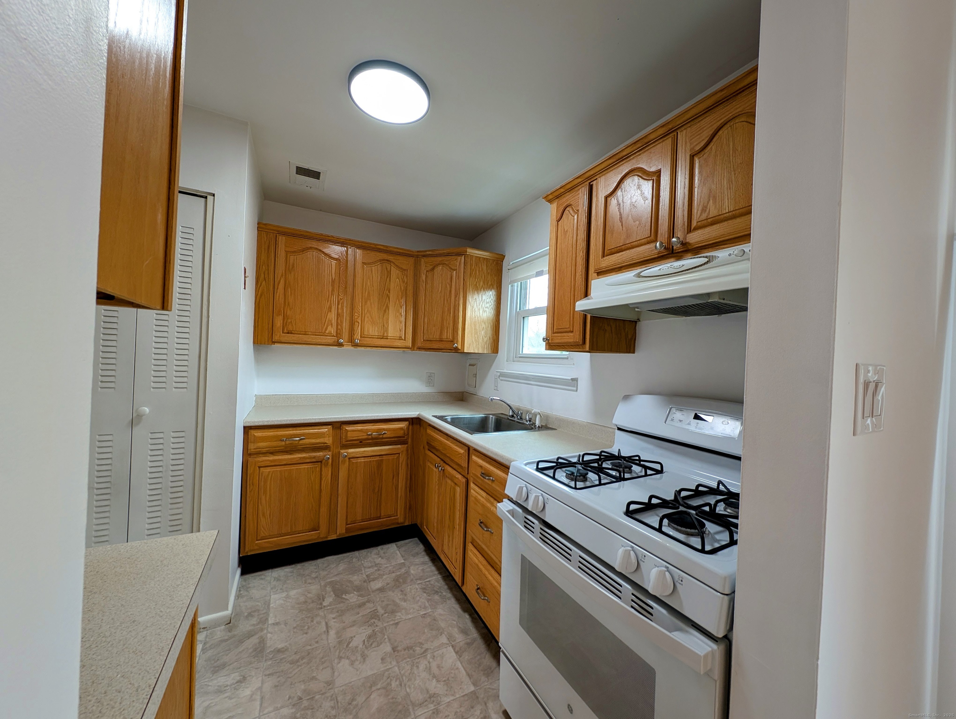 23 Shea Avenue, Unit 23 Milford, CT 06460 - Photo 7 of 16 a kitchen with stainless steel appliances granite countertop a stove and a refrigerator