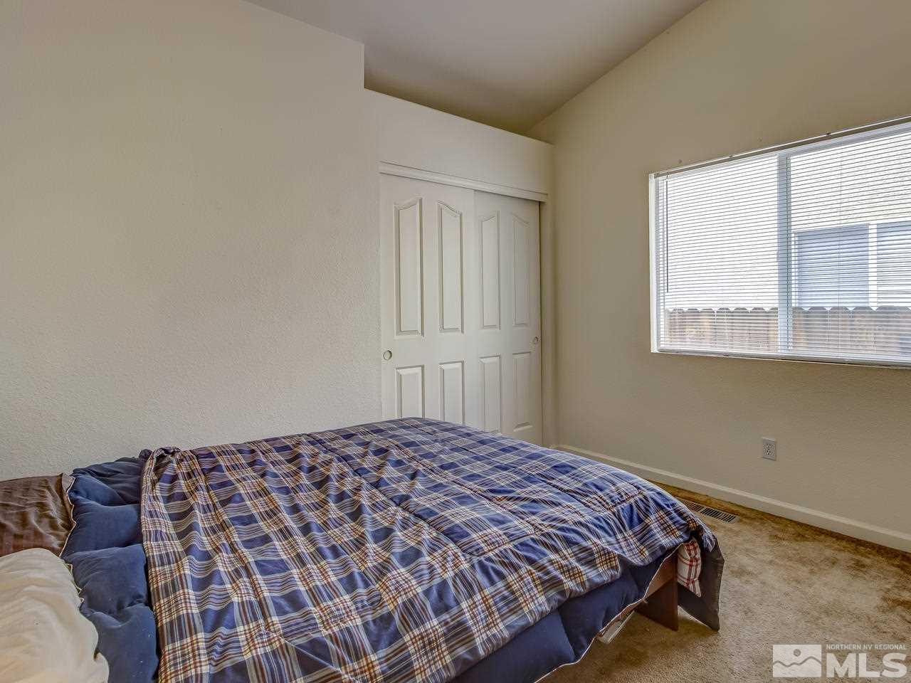 9665 Oakley Lane Reno, NV 89521 - Photo 17 of 23 a bedroom with a bed and window