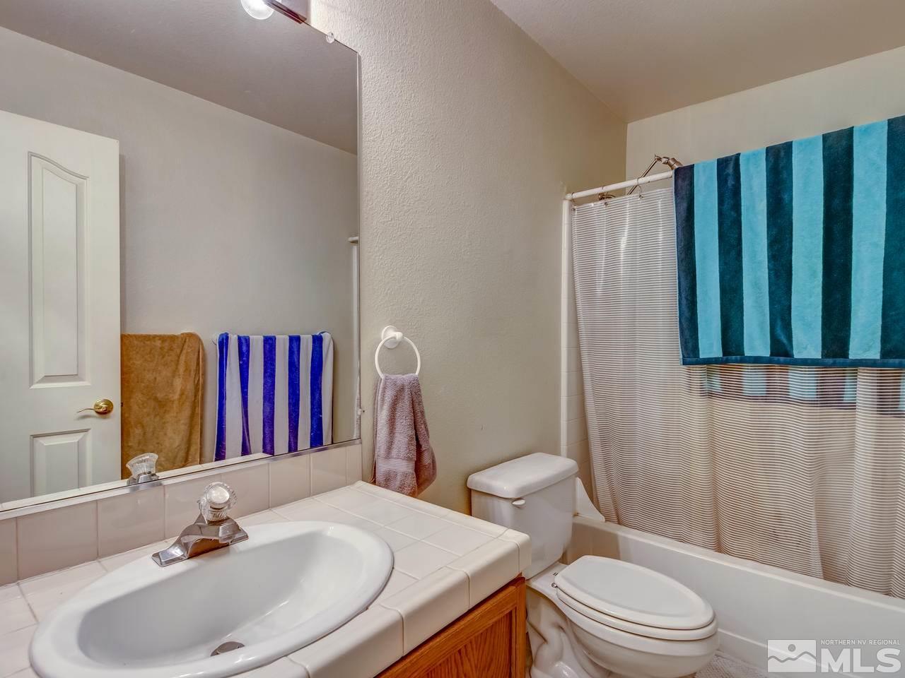 9665 Oakley Lane Reno, NV 89521 - Photo 19 of 23 a bathroom with a sink and a mirror