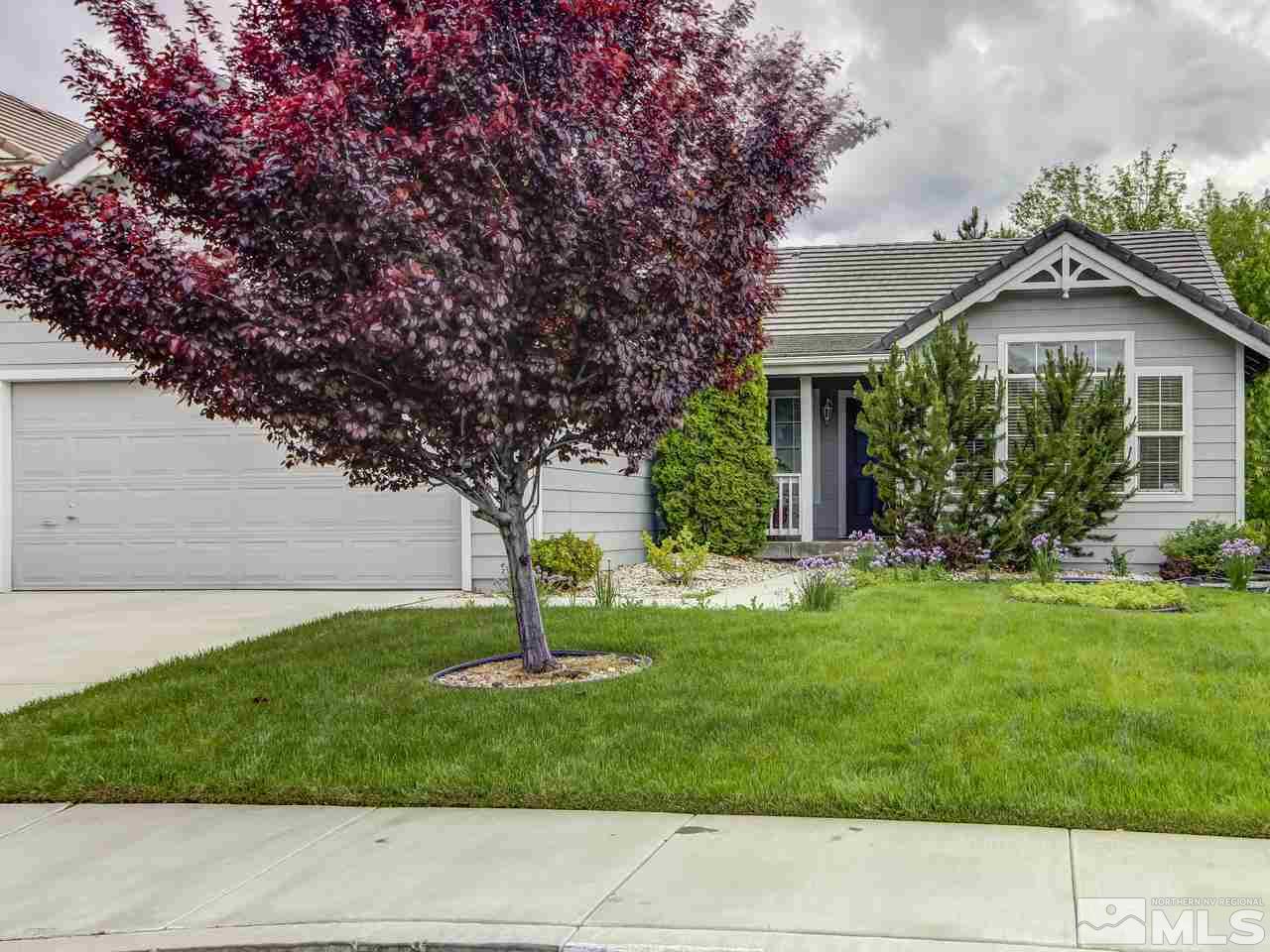 9665 Oakley Lane Reno, NV 89521 - Photo 2 of 23 a front view of a house with a garden