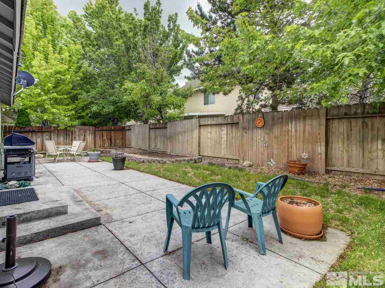 9665 Oakley Lane Reno, NV 89521 - Photo 21 of 23 a backyard of a house with table and chairs