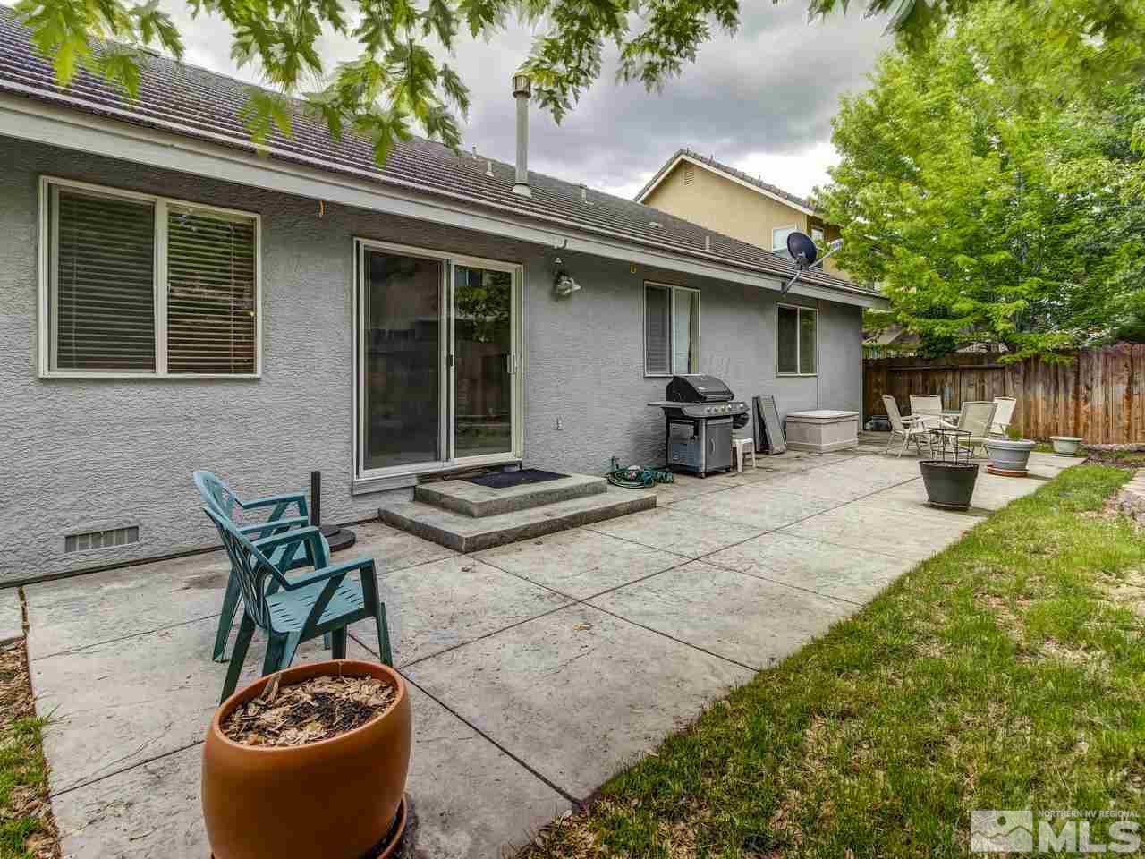 9665 Oakley Lane Reno, NV 89521 - Photo 22 of 23 a backyard of a house with table and chairs