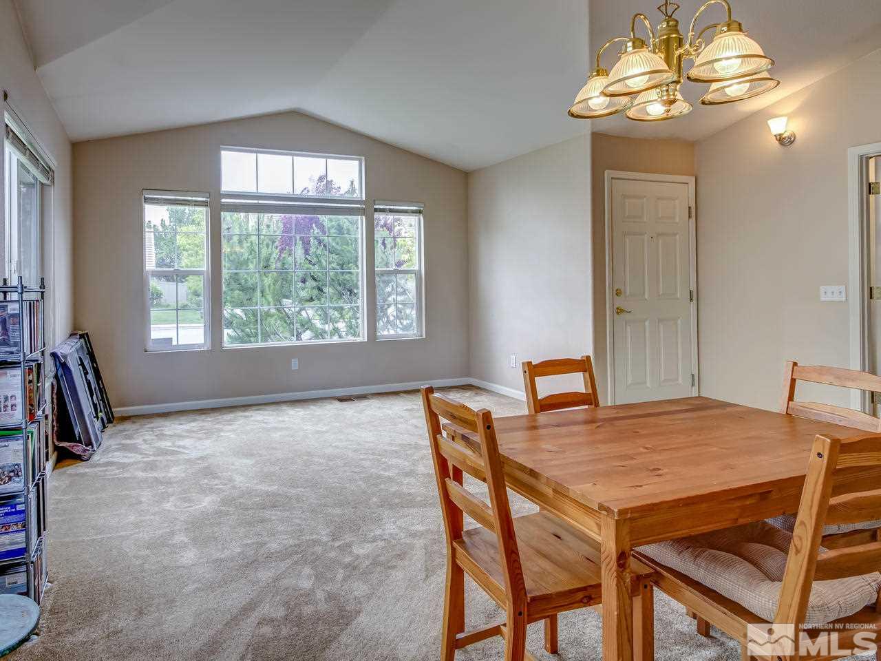 9665 Oakley Lane Reno, NV 89521 - Photo 4 of 23 a view of a dining room with furniture window and outside view