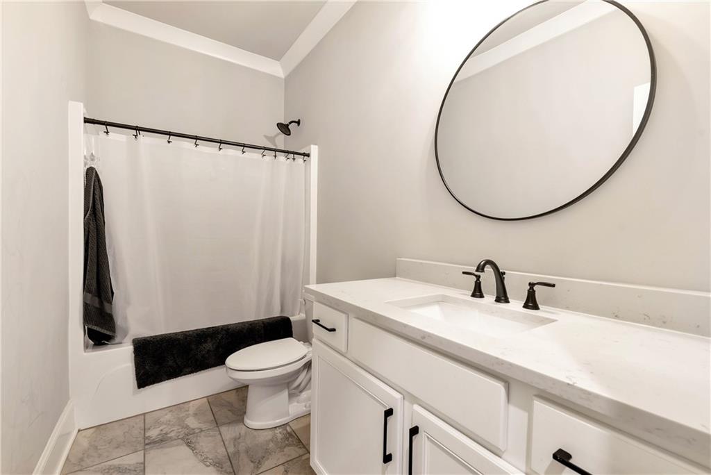 6140 Crescent Moon Ridge Cumming, GA 30041 - Photo 43 of 54 a bathroom with a sink a toilet and a mirror