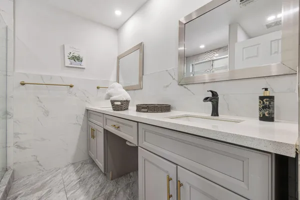 a bathroom with a sink toilet and mirror