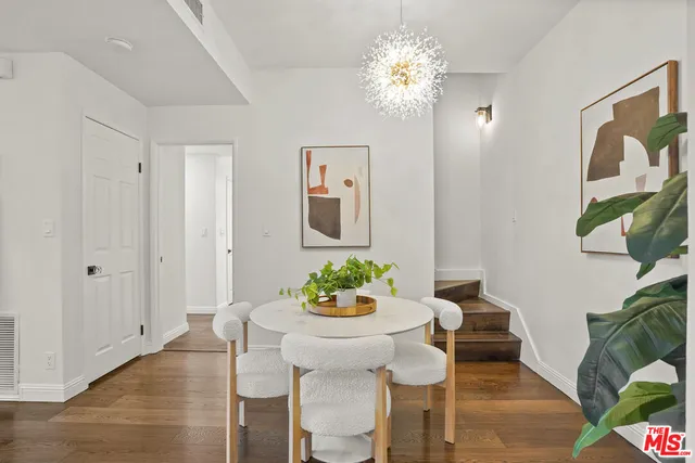 a roof deck with couches and wooden floor