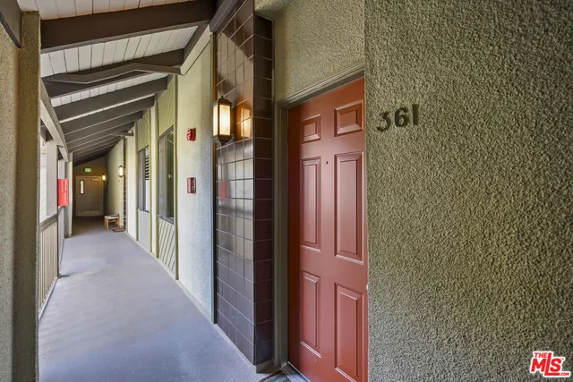 a living room with furniture fireplace and a large window