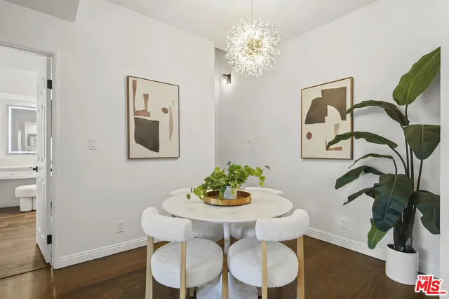 a balcony with wooden floor and outdoor seating