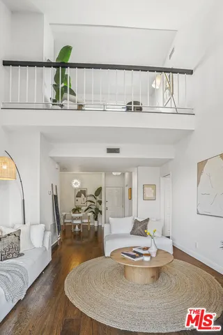a bedroom with a bed couch and a potted plant