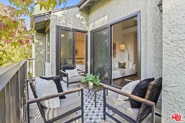 a spacious bathroom with a granite countertop sink a toilet and a mirror