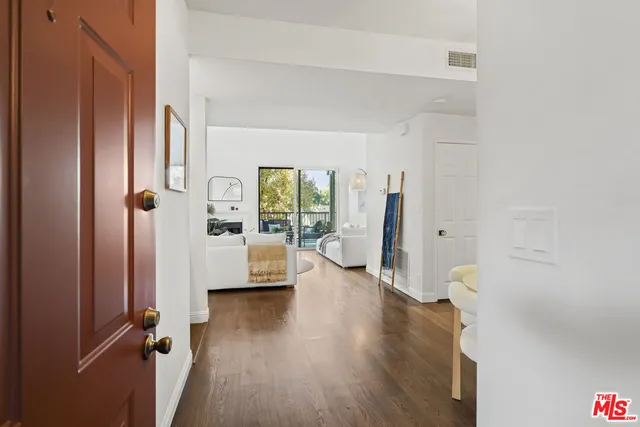 a living room with furniture a fireplace and a potted plants next to a window