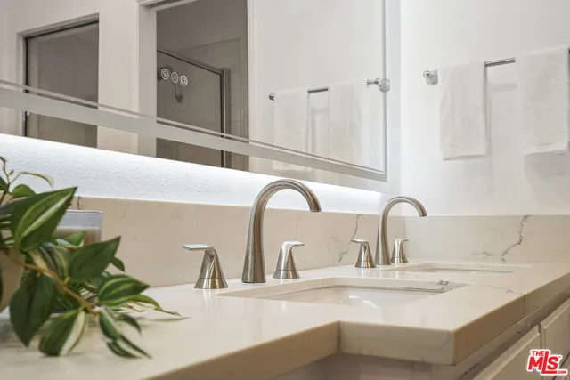 a bathroom with a sink vanity granite and toilet