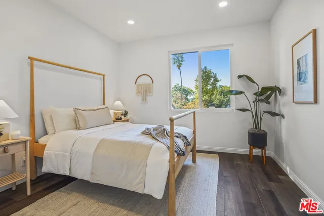 a bedroom with furniture and a potted plant