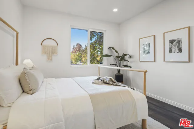 a view of a bedroom with a bed and hallway