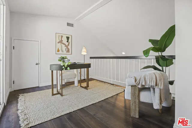 a living room with fireplace furniture and a wooden floor