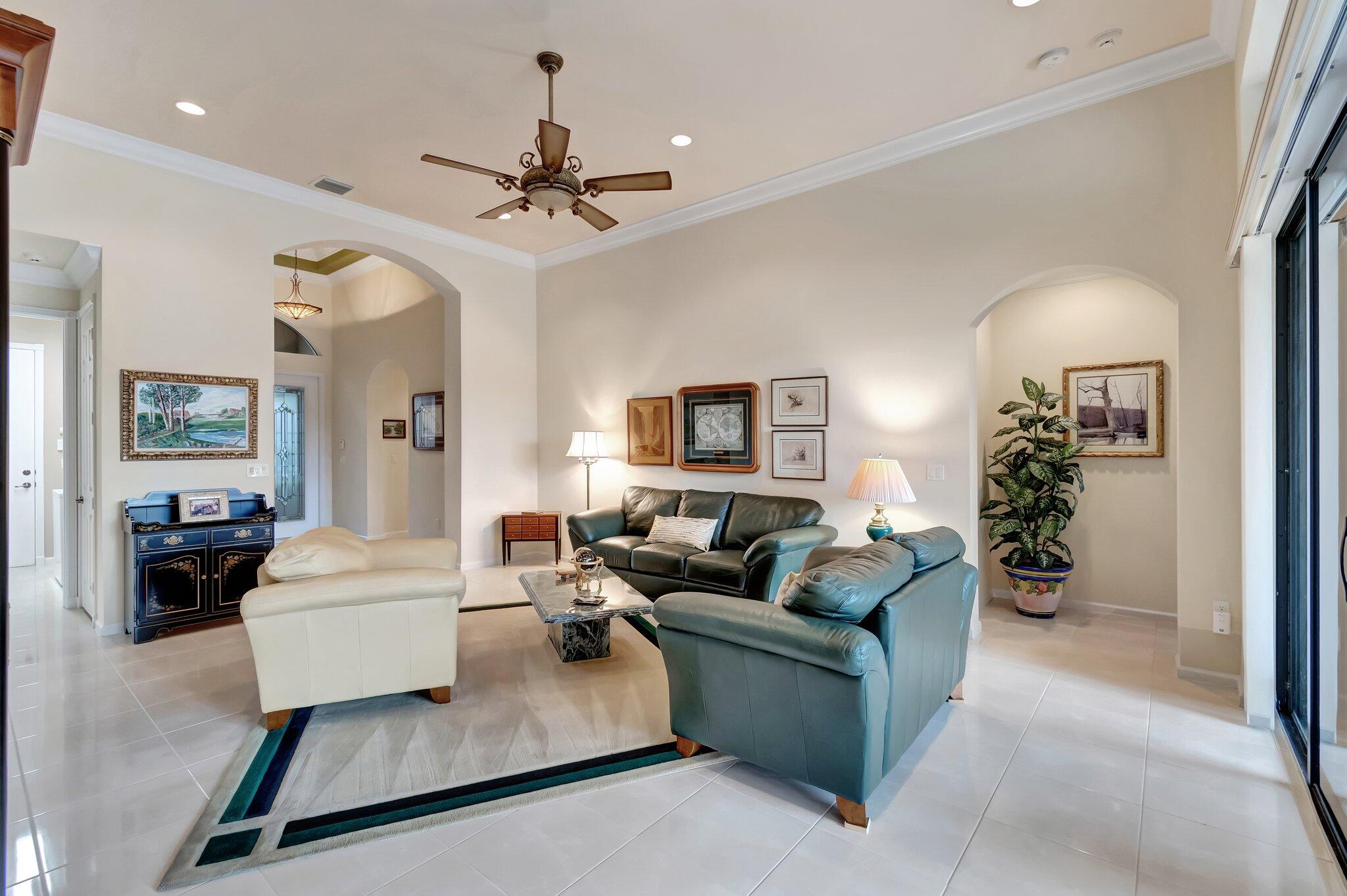 6976 Antinori Lane Boynton Beach, FL 33437 - Photo 17 of 71 a living room with furniture and a chandelier
