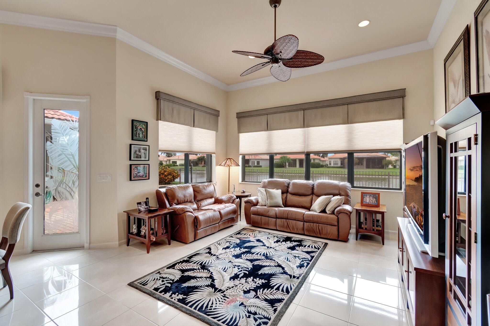 6976 Antinori Lane Boynton Beach, FL 33437 - Photo 26 of 71 a living room with furniture ceiling fan and a large window