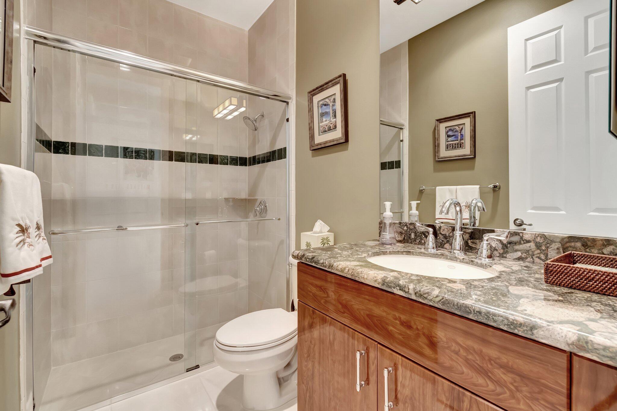 6976 Antinori Lane Boynton Beach, FL 33437 - Photo 38 of 71 a bathroom with a granite countertop sink toilet and shower
