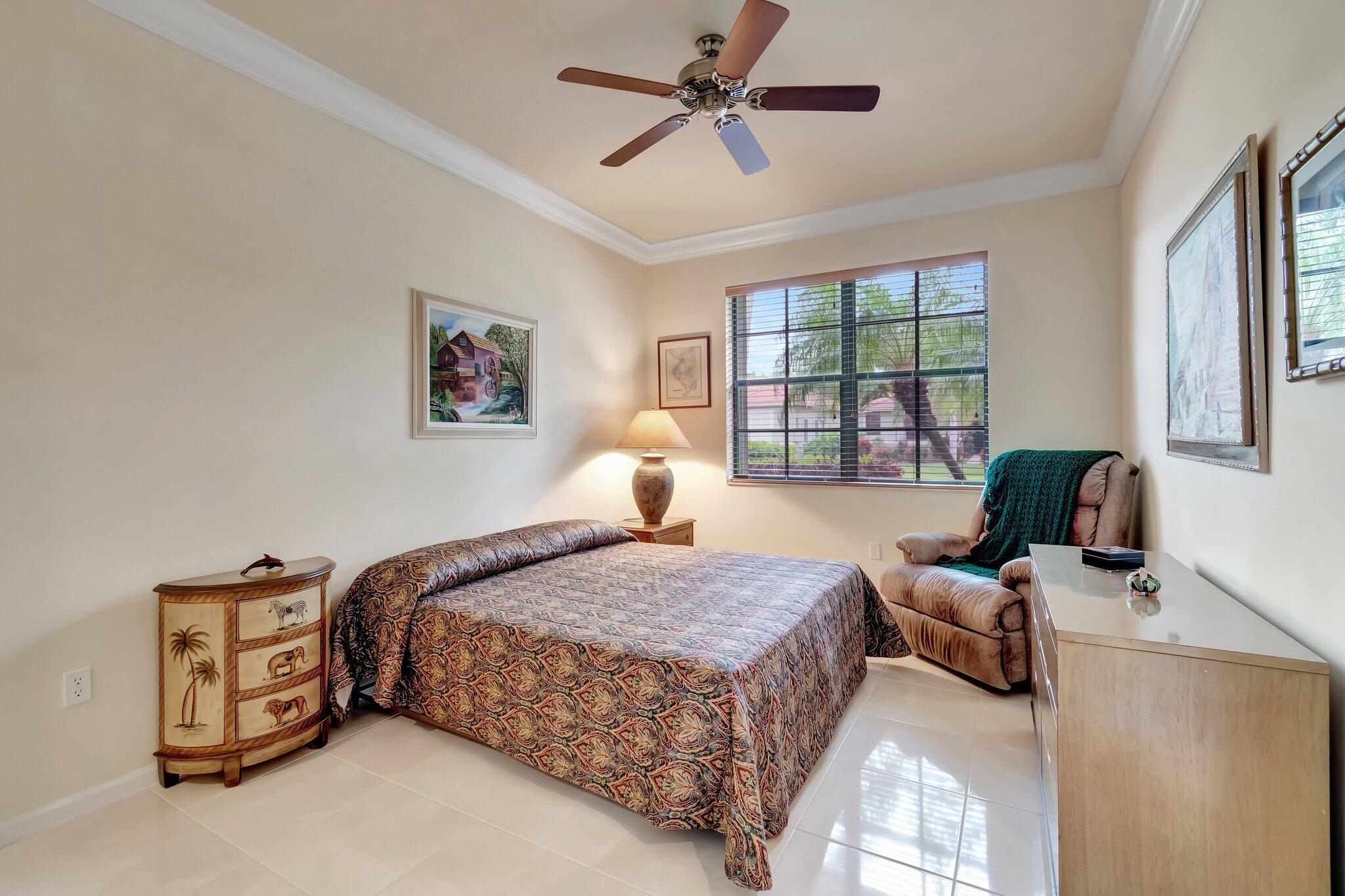 6976 Antinori Lane Boynton Beach, FL 33437 - Photo 40 of 71 a bedroom with a bed couch and window