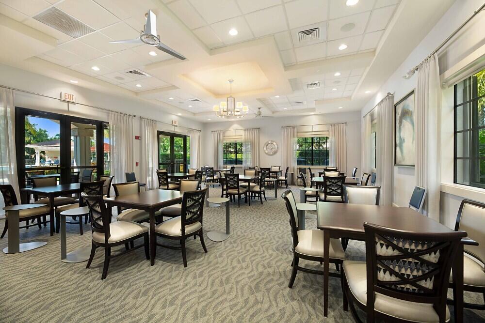 6976 Antinori Lane Boynton Beach, FL 33437 - Photo 67 of 71 a view of a dining room with furniture window and wooden floor
