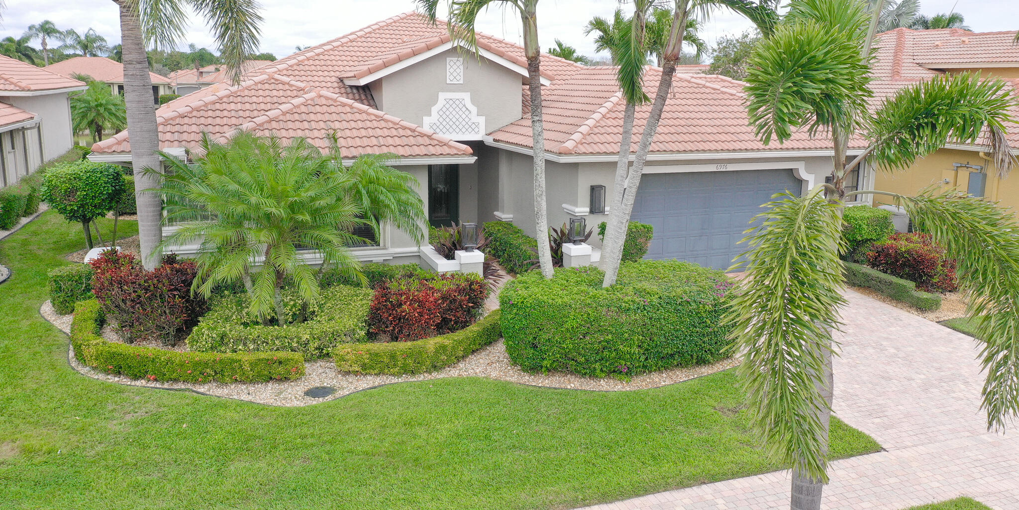 6976 Antinori Lane Boynton Beach, FL 33437 - Photo 9 of 71 a front view of a house with garden