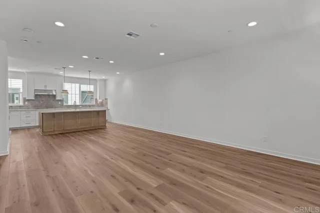 a view of kitchen with wooden floor and windows