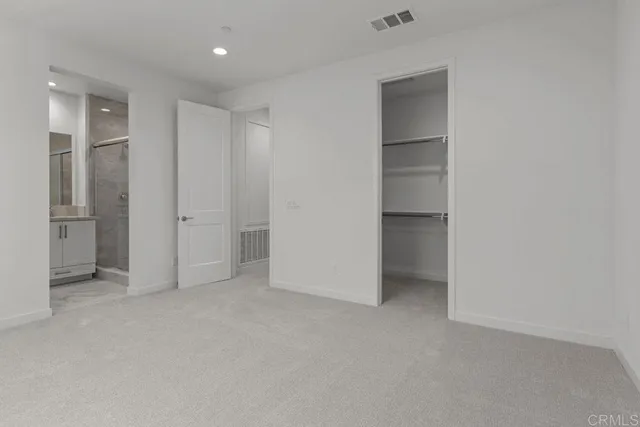 an empty room with closet and wooden door