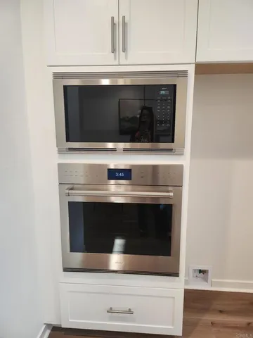 a stove top oven sitting inside of a kitchen