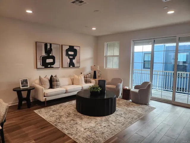 a living room with furniture and wooden floor