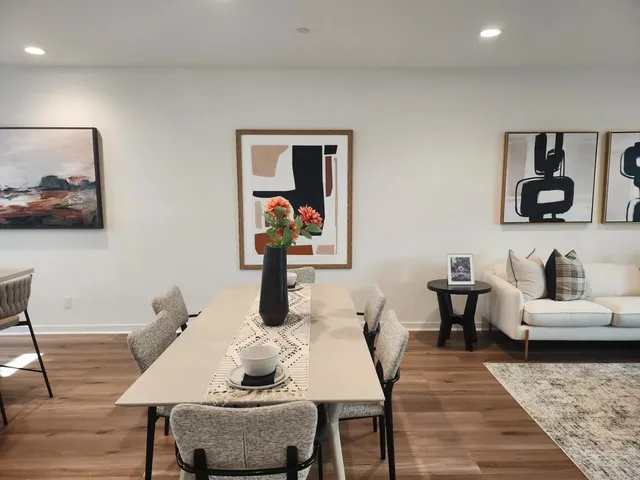 a living room with furniture and wooden floor