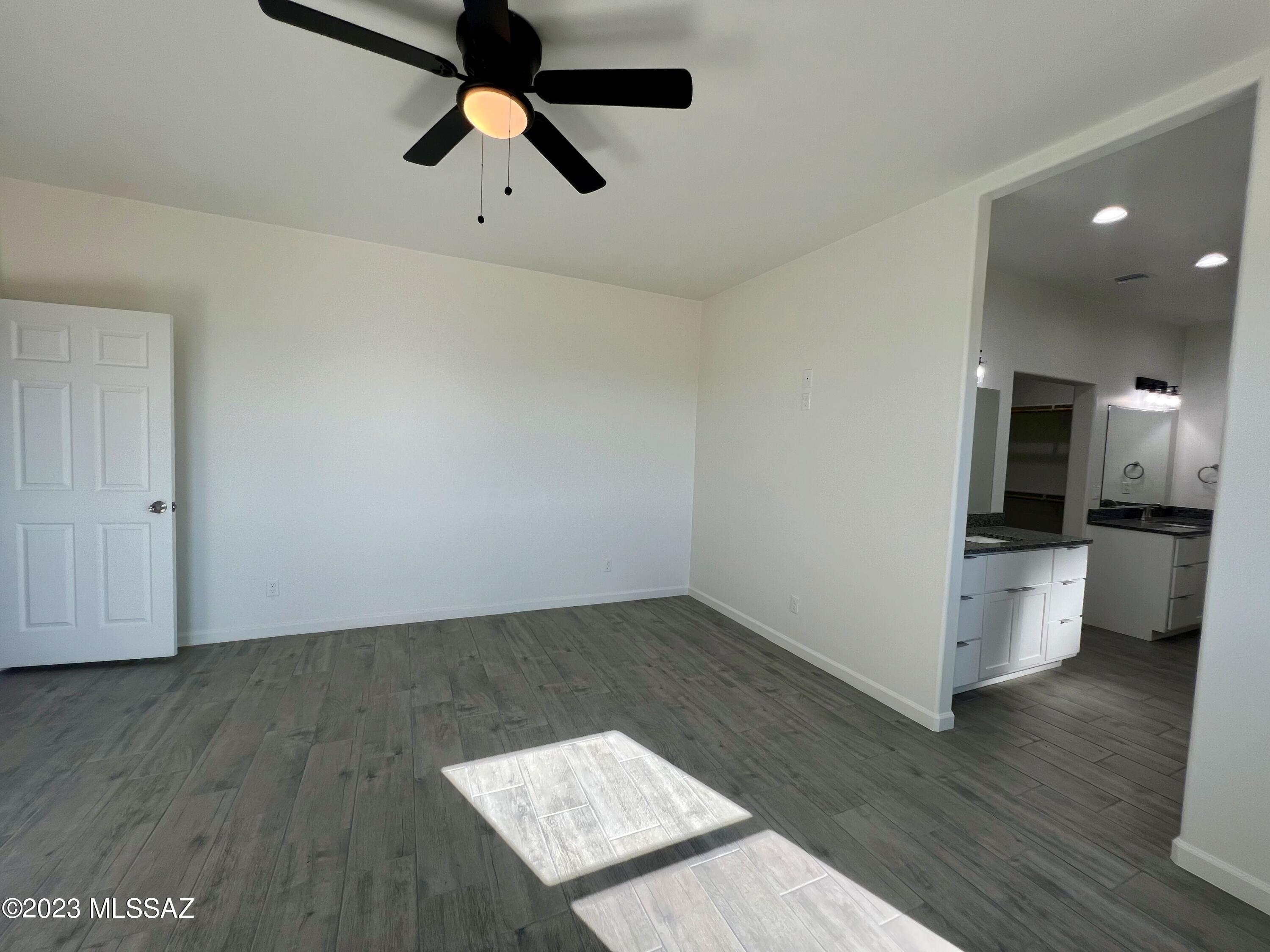 353 Dock Street Rio Rico, AZ 85648 - Photo 20 of 50 a view of an empty room and window wooden floor