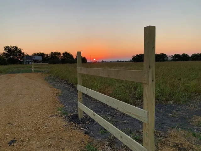 a view of a lake with a yard from a tub
