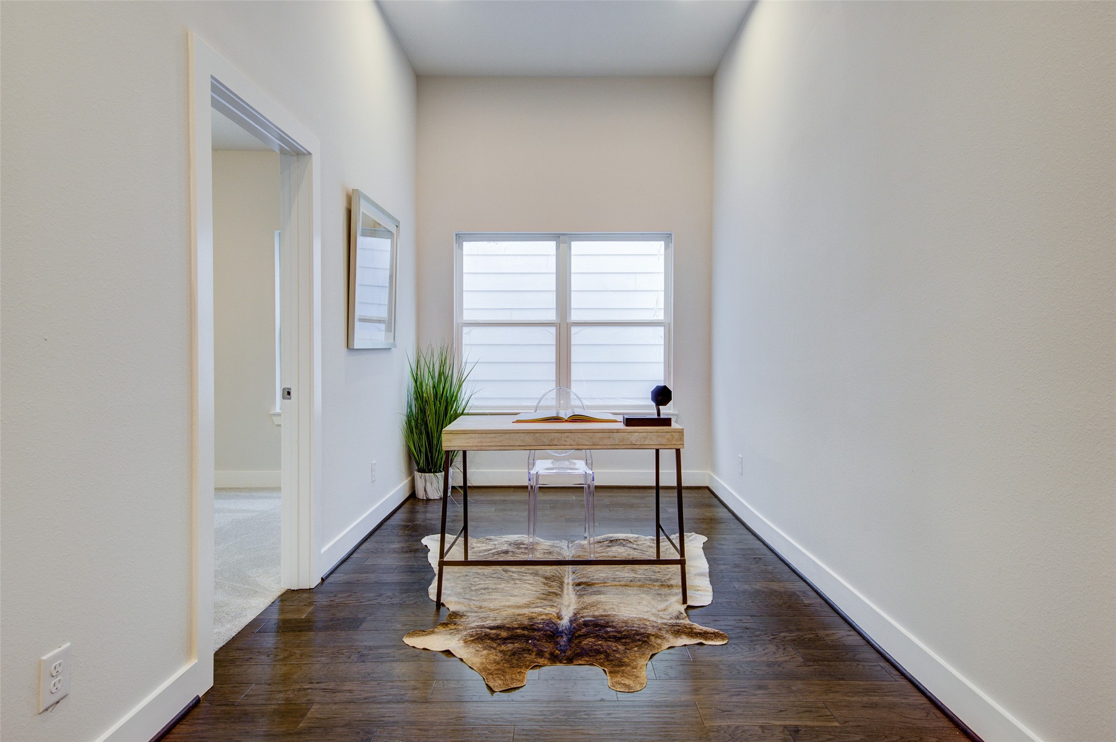 853 Mansfield Street, Unit A Houston, TX 77091 - Photo 6 of 16 This dedicated home office space is perfect for remote work or study, offering a quiet and comfortable environment. With plenty of natural light, sleek furnishings, and ample workspace, this office ensures productivity and focus. The minimalist design and modern decor create an inspiring setting for any professional.