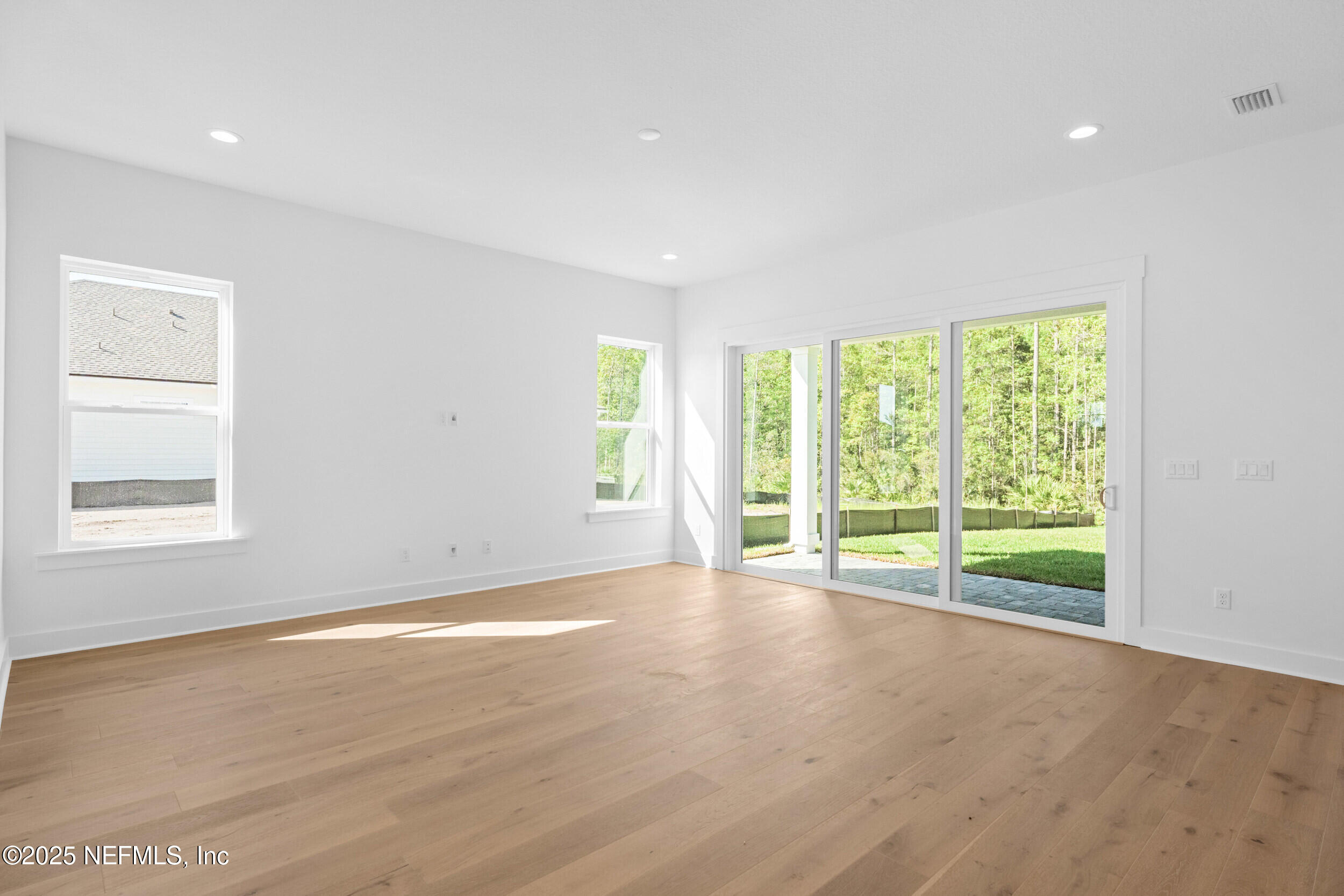 103 Reflections Avenue Ponte Vedra, FL 32081 - Photo 18 of 38 a view of an empty room with wooden floor and a window