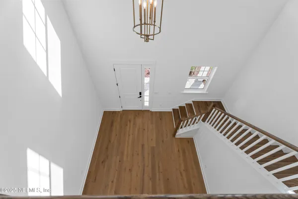 a view of wooden floor and windows in a room