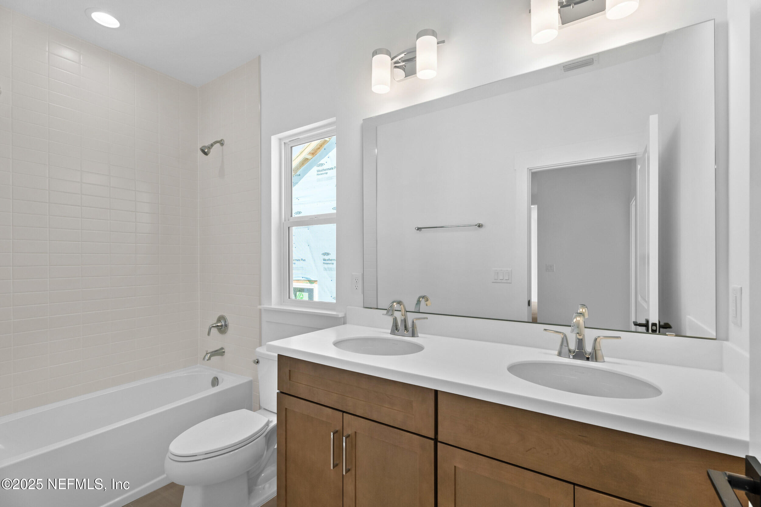 103 Reflections Avenue Ponte Vedra, FL 32081 - Photo 23 of 38 a bathroom with a granite countertop sink a toilet and a large mirror