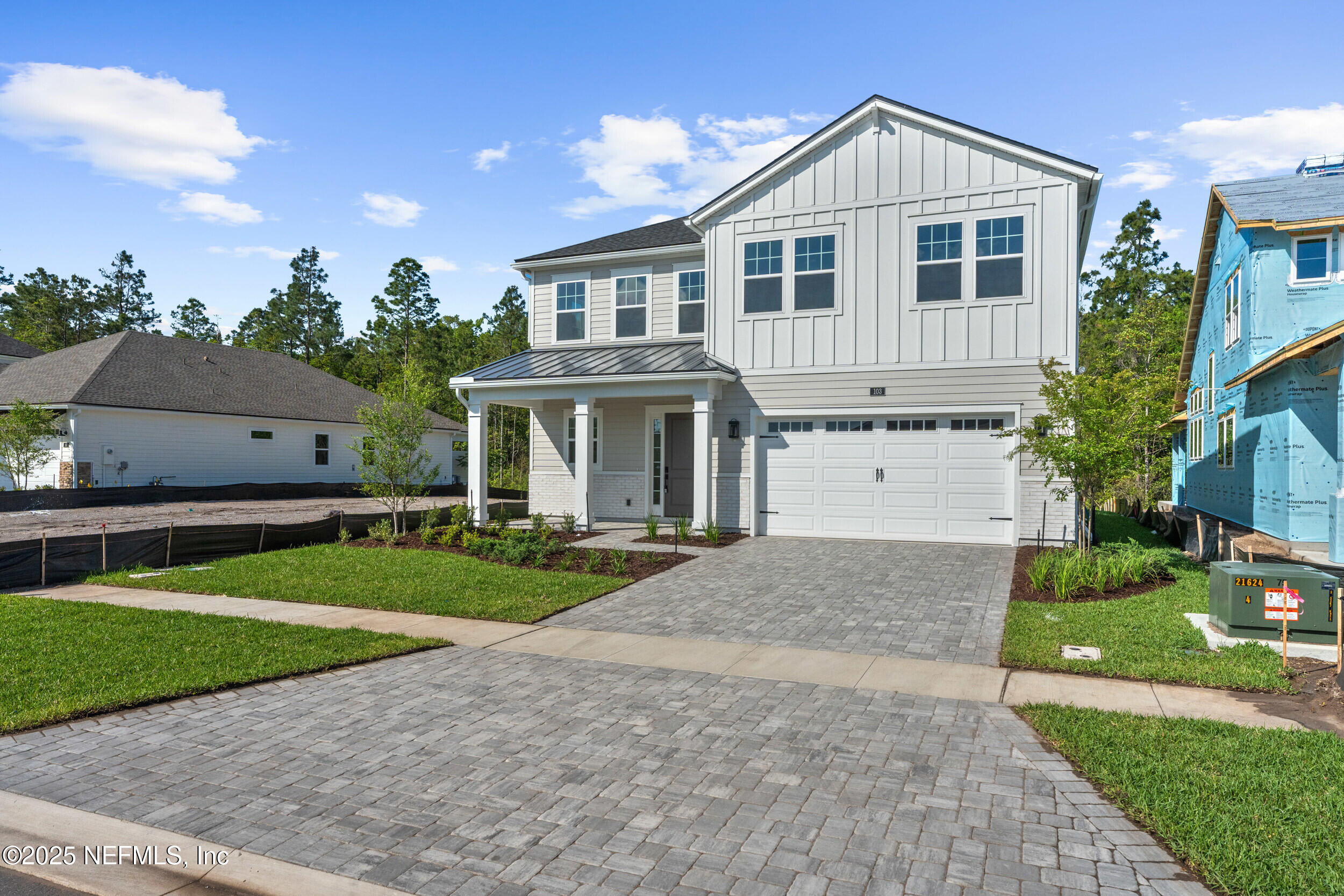 103 Reflections Avenue Ponte Vedra, FL 32081 - Photo 3 of 38 a front view of a house with a yard and garage