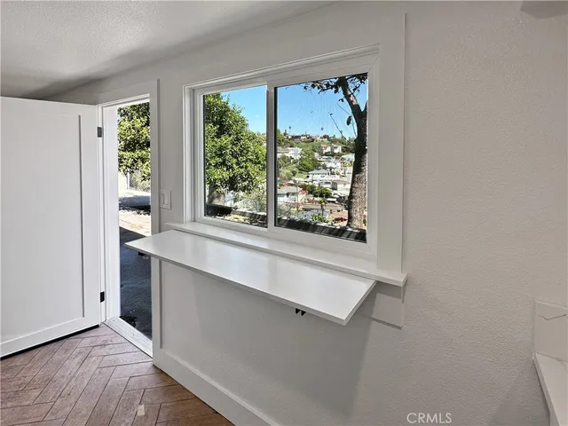 a kitchen with white cabinets a sink and white appliances
