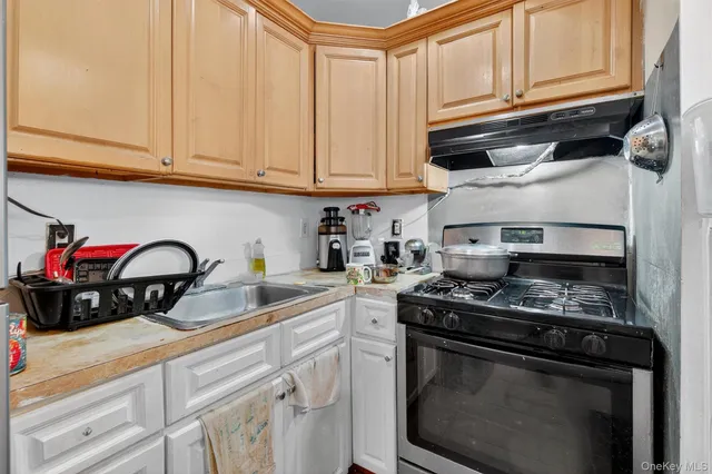 a living room with furniture a flat screen tv and a window