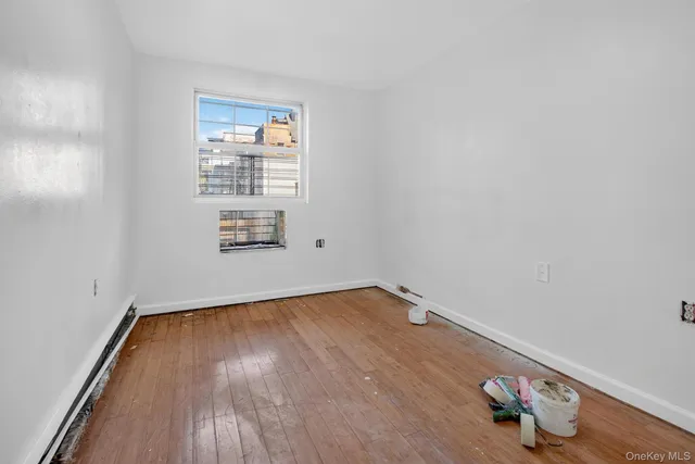 a view of an empty room and wooden floor