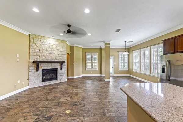 a view of an empty room with a fireplace and a window